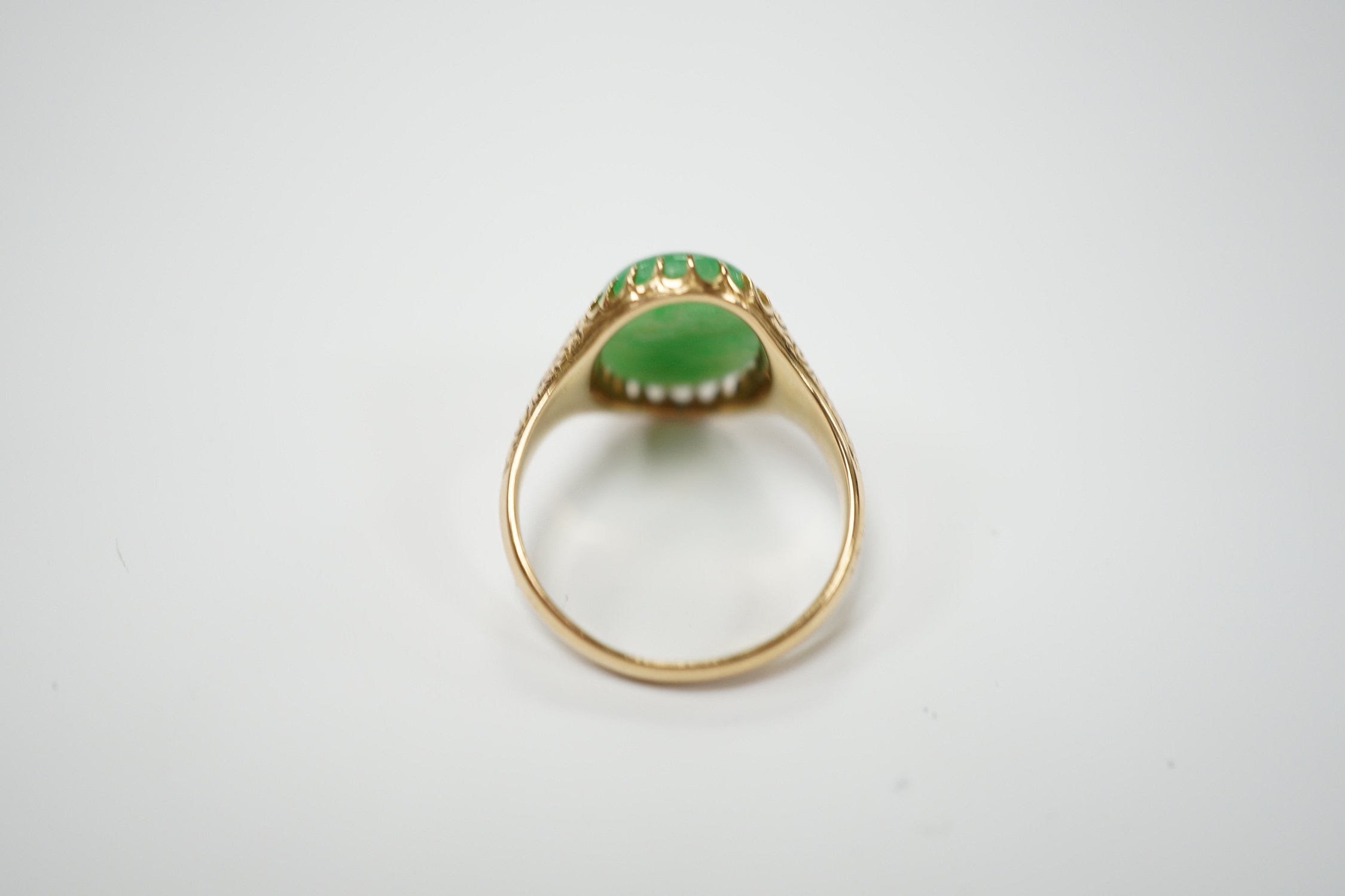 A yellow metal (stamped 18) and single stone cabochon jade set ring, size Q, gross weight 5.7 grams.